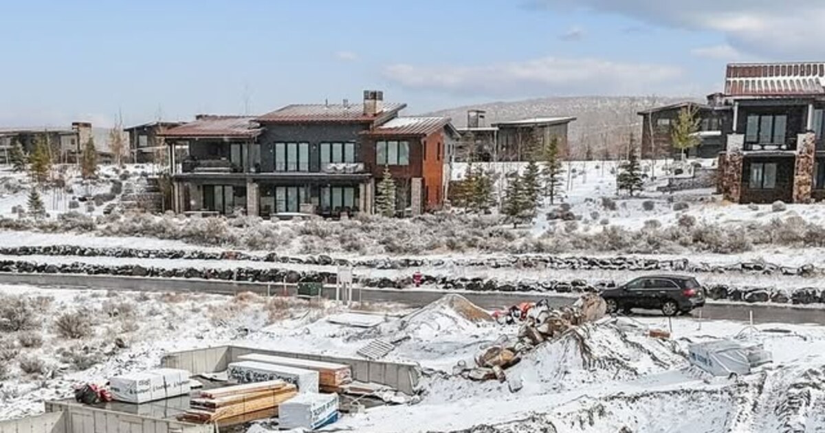 Exposed concrete foundation walls on a snowy Park City custom-home site