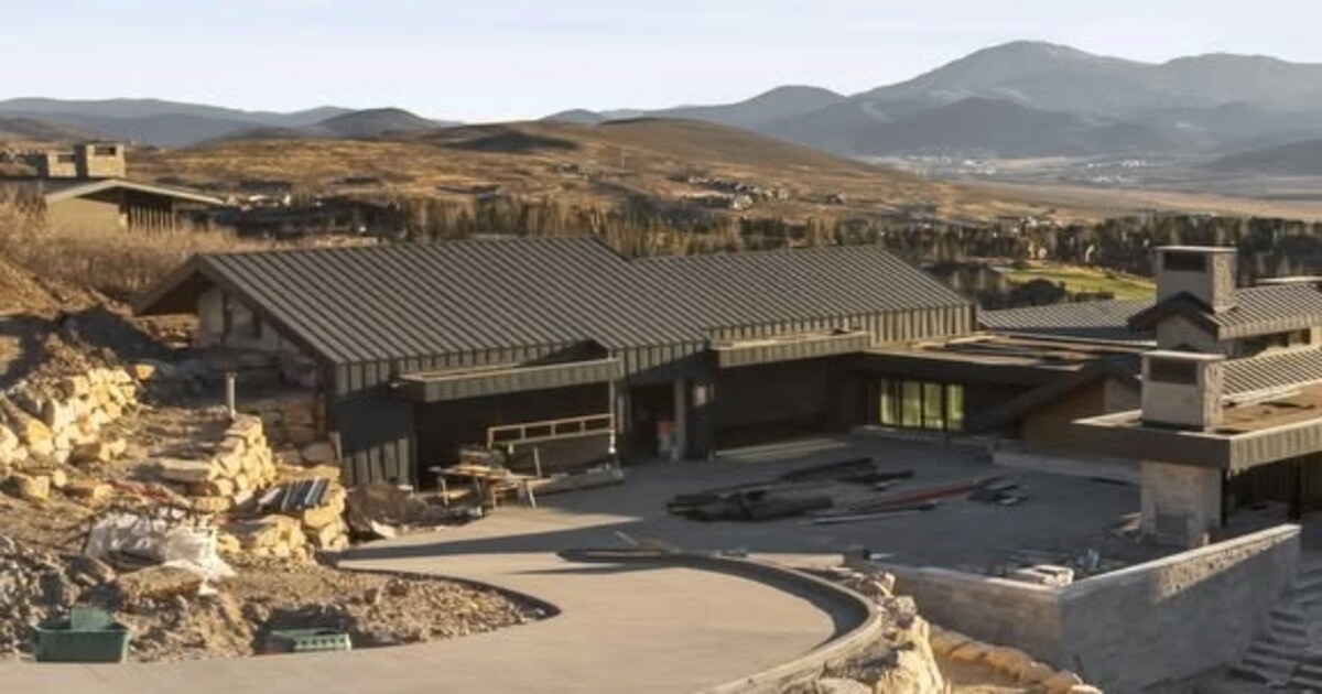 Mountain custom-home site with a broad paved approach and surrounding hills